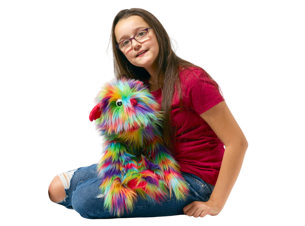 Girl holding a colorful fluffy toy on a white background