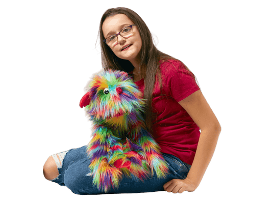 Girl holding a colorful fluffy toy on a white background