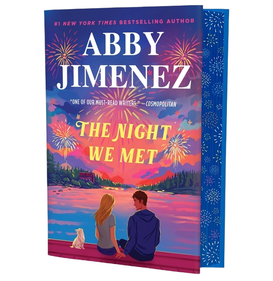 Book cover of 'The Night We Met' by Abby Jimenez with a couple and dog by a lake at sunset.