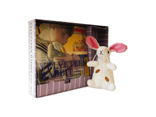Plush rabbit toy next to a book titled 'The Velveteen Rabbit' on a green background